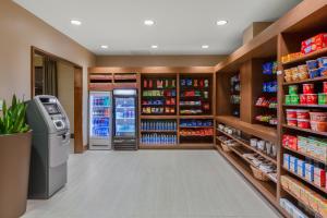a grocery store aisle with a refrigerator and shelves at Holiday Inn La Mirada Buena Park by IHG in La Mirada