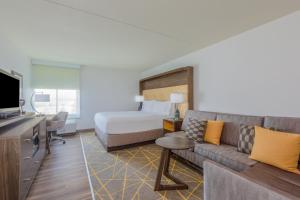 a hotel room with a bed and a couch at Holiday Inn La Mirada Buena Park by IHG in La Mirada