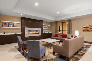 a living room with a couch and a fireplace at Holiday Inn La Mirada Buena Park by IHG in La Mirada