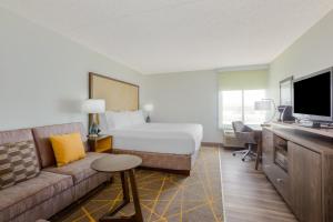 a hotel room with a bed and a couch at Holiday Inn La Mirada Buena Park by IHG in La Mirada