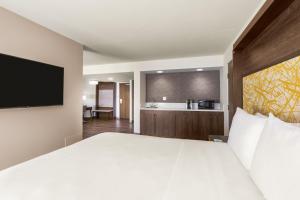 a hotel room with a large bed and a bathroom at Holiday Inn La Mirada Buena Park by IHG in La Mirada