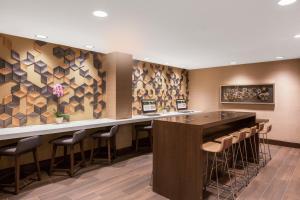a bar in a hotel lobby with stools at Holiday Inn La Mirada Buena Park by IHG in La Mirada