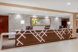 a lobby of a hotel with a reception desk at Holiday Inn La Mirada Buena Park by IHG in La Mirada