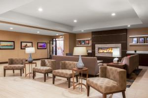 a waiting room with chairs and a fireplace at Holiday Inn La Mirada Buena Park by IHG in La Mirada
