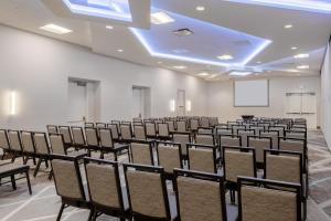 an empty room with chairs and a projection screen at Holiday Inn La Mirada Buena Park by IHG in La Mirada