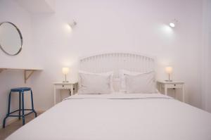 a bedroom with a large white bed with two tables at Salum in Trogir