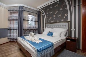 a bedroom with a bed with a towel on it at Illés Hotel in Szeged