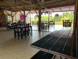 a dining room with tables and chairs in a building at Finca Hotel la Manuela in Armenia