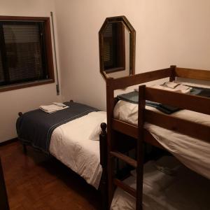 a bedroom with two bunk beds and a mirror at Afurada Apartment - 2 Room - 3 Persons in Vila Nova de Gaia