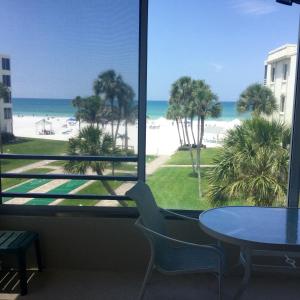 a view of the beach from a room with a table and chairs at Island House Beach Resor 13N in Point O'Rocks