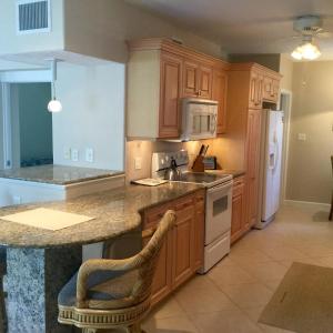 a kitchen with wooden cabinets and a counter top at Island House Beach Resor 13N in Point O'Rocks