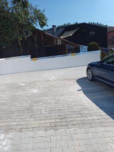 a car parked in a parking lot next to a white wall at da GIUSEPPE in Tuttlingen