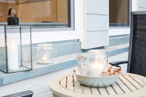 a table with a candle on a porch with a window at Dat-Meerhus in Büsum