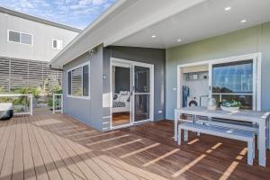 a home with a patio with a table and bench at Seascape Scotts Head in Scotts Head