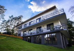 a house with balconies on the side of it at Blis Apartamenty in Lubliniec