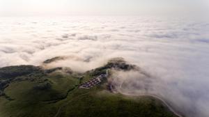 an island in the middle of a field of clouds at Flora Handüzü Resort Bungalow in Rize