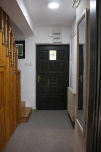 a hallway with a black door in a building at Green door in Vrnjačka Banja