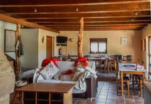 a living room with a couch and a table at Albergue A'Noguera in Castiello de Jaca