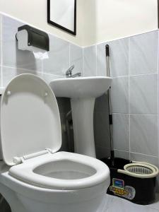 a bathroom with a white toilet and a sink at Condo w/ Balcony Near Mactan International Airport in Mactan