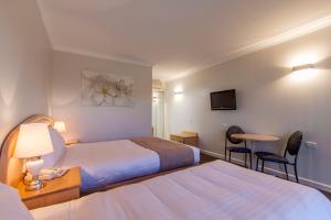 Postel nebo postele na pokoji v ubytování Sunshine Motor Inn