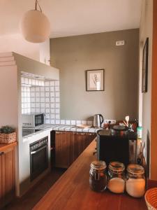 a kitchen with a table with jars on it at Siedlisko na Wzgórzu in Wizna +20 photos