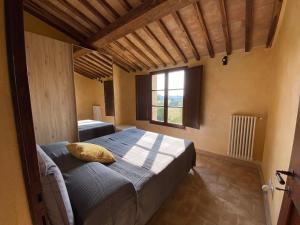 a bedroom with a bed in a room with a window at Tuscany Charme Boutique House in Monteroni dʼArbia +11 photos