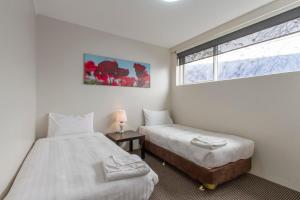 Postel nebo postele na pokoji v ubytování Sunshine Motor Inn