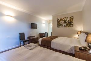 Postel nebo postele na pokoji v ubytování Sunshine Motor Inn