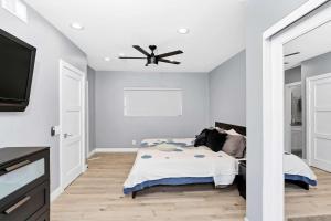 a bedroom with a bed and a ceiling fan at 308 35th Street, Unit A (Lower) in Newport Beach +21 photos
