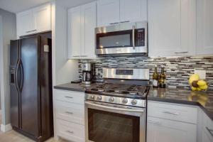a kitchen with a stainless steel stove and a microwave at 308 35th Street, Unit A (Lower) in Newport Beach