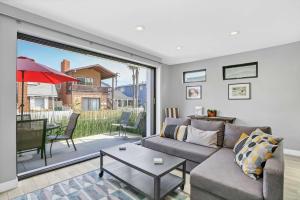 a living room with a couch and a table at 308 35th Street, Unit A (Lower) in Newport Beach