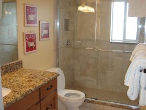 a bathroom with a shower and a toilet at Island House Beach Resort 12N in Point O'Rocks
