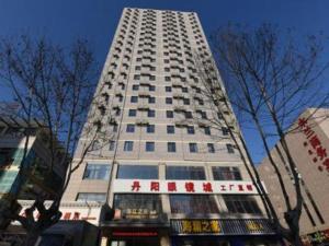 a tall white building with chinese writing on it at JinJiang Inn Pinshang Suqian Shuyang Renming Roa in Suqian