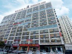 a large building with cars parked in front of it at Jinjiang Inn Select Wuxi Nanchang Street Huaqing Bridge Metro Station in Wuxi