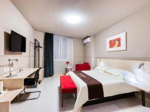 a hotel room with a bed and a desk and a sink at Jinjiang Inn Xinchang Gushan Road Big Buddha Temple in Xinchang