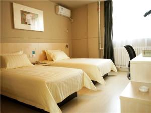 a hotel room with two beds and a window at Jinjiang Inn Yingkou Port Authority Bayuquan Century Plaza in Yingkou