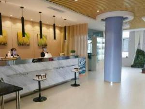 a lobby with a counter in a restaurant with people at Jinjiang Inn Huludao Longgang Haibin Branch in Huludao