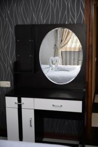 a mirror on top of a dresser in a bathroom at Royal Plus Hotel in Yerevan