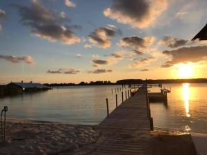 a dock on a body of water with a sunset at The Quarters at Pier450 in Ridge +27 photos