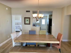 a dining room with a wooden table and chairs at Island House Beach Resort 12S in Point O'Rocks