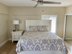 a bedroom with a bed and a ceiling fan at Island House Beach Resort 12S in Point O'Rocks