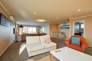 a living room with a couch and two chairs at The Lookout, Spacious, Stunning Views - KK12632 in Kaikoura