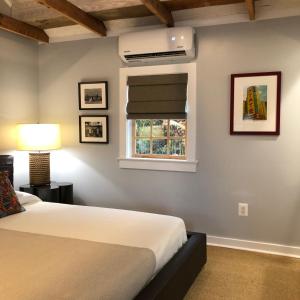 a bedroom with a bed and a window at The Quarters at Pier450 in Lexington Park