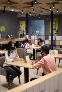 a group of people sitting at a table wearing virtual reality glasses at YELLO Hotel Paskal Bandung in Bandung
