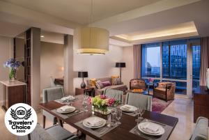a living room with a table and chairs and a dining room at Ascott Kuningan Jakarta in Jakarta