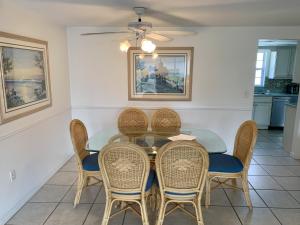 a dining room with a table and chairs at Island House Beach Resort 9 in Siesta Key