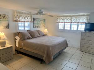 a bedroom with a bed and two windows at Island House Beach Resort 9 in Siesta Key