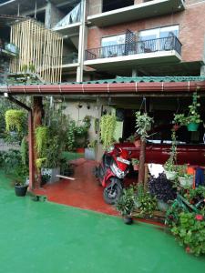 a scooter parked under a building with potted plants at Lucky Star Ella in Ella