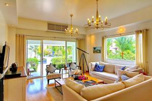 a living room with a couch and a table at Koh Chang Beach Front 5 Bedroom Villa in Ko Chang