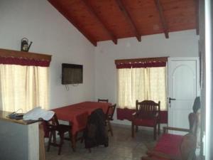 a dining room with a red table and chairs at Posada Rural Crisol de Razas in San Vicente